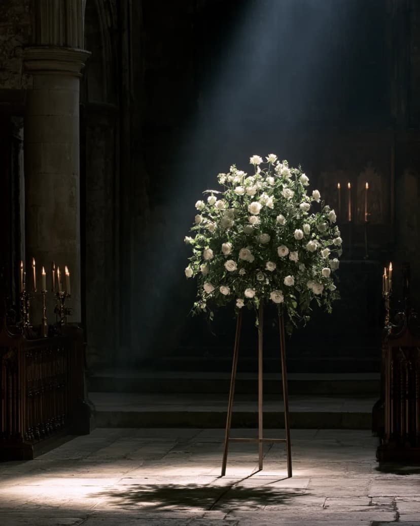A standing spray of white roses in the chapel.